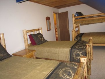 3rd floor bedroom with 3 twin beds and one queen bed